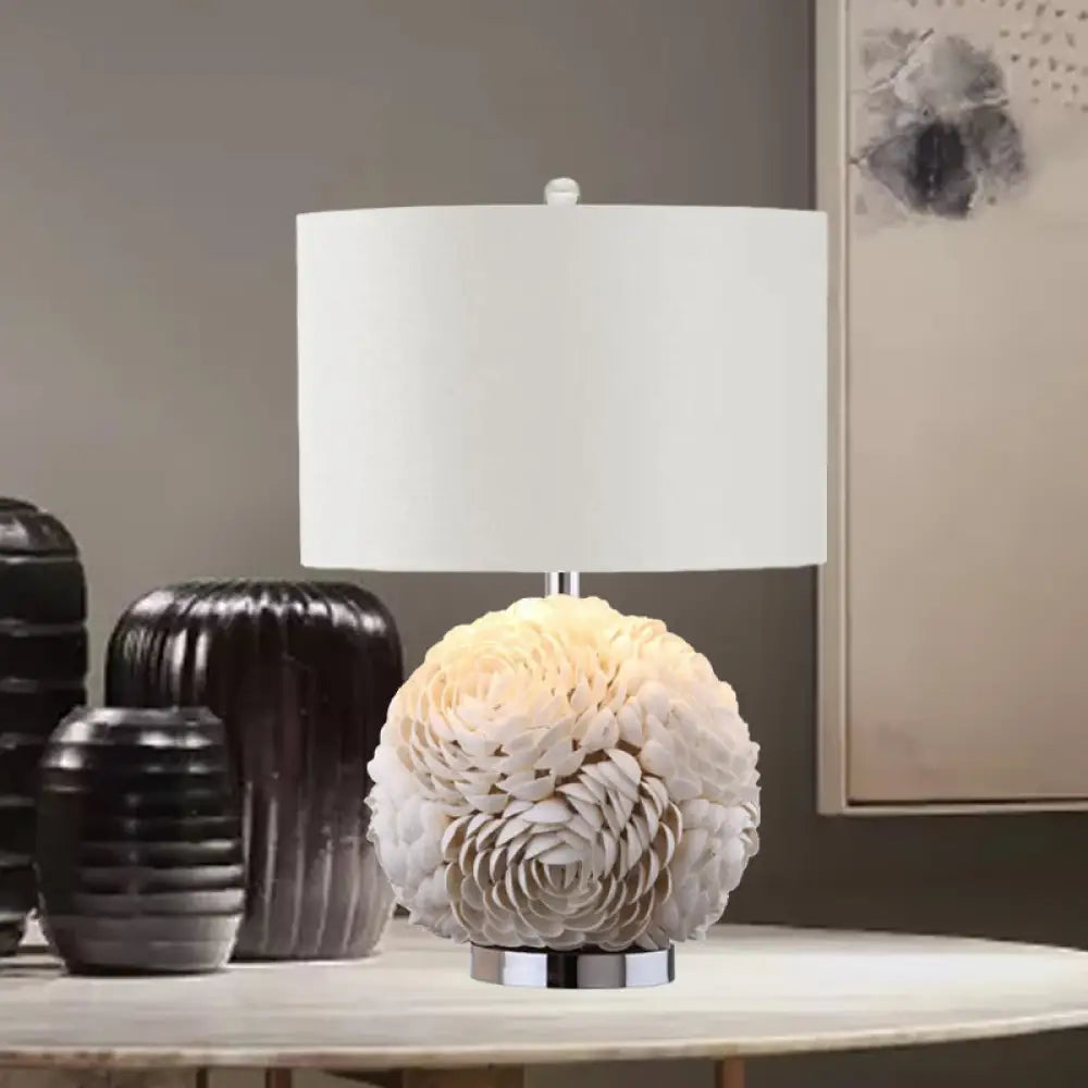 metal table lamps with a matte black finish for a sleek appearancemetal table lamps with a matte black finish for a sleek appearanceSophie - Rustic Charm: Rose Globe Shell 1-Light White Nightstand Lamp